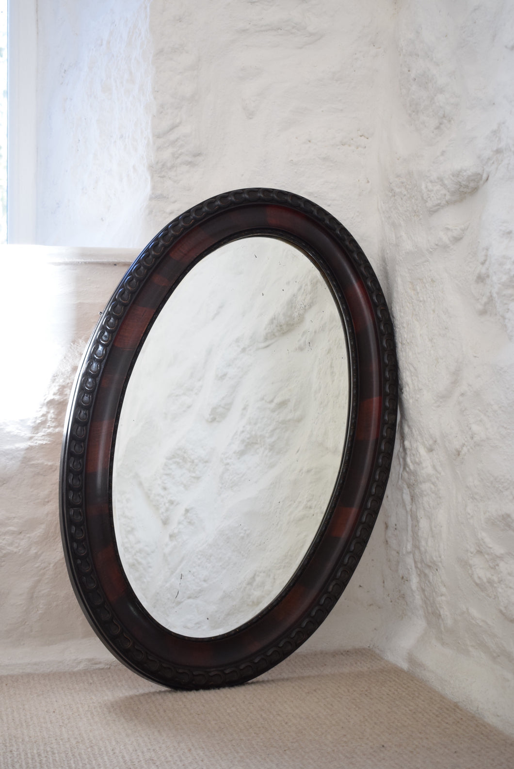 black and red oval mirror