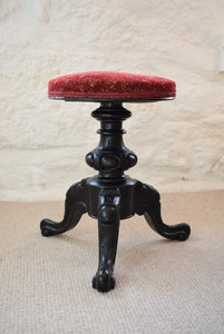 Antique red padded piano stool