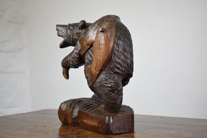 carved wooden bear with salmon